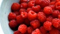 Juicy red raspberries in a bowl. Raspberry harvesting. Vitamin berries. Royalty Free Stock Photo