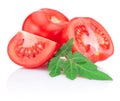 Juicy red tomato, half and slice with leaves Royalty Free Stock Photo