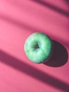 Juicy, ripe apple on a pink background Royalty Free Stock Photo