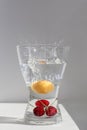 Juicy ripe fruit red cherries floating in a glass vessel in clear transparent water with air bubbles Royalty Free Stock Photo