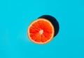 Juicy ripe grapefruit on blue background