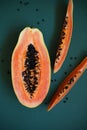 juicy ripe papaya halves on green background, tropical fruit close-up