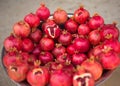 Juicy and ripe pomegranate with peel taken off, exposing fresh seeds, laying on pile of pomegranates Royalty Free Stock Photo