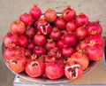 Juicy and ripe pomegranate with peel taken off, exposing fresh seeds, laying on pile of pomegranates Royalty Free Stock Photo