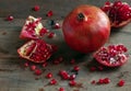 Juicy ripe pomegranates on a wooden table.