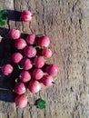 Juicy ripe red berries of a gooseberry on a wooden background. Copy space. Gooseberry harvest Royalty Free Stock Photo