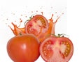 Juicy ripe red tomatoes and a splash of tomato juice. Isolate Royalty Free Stock Photo