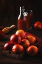 Juicy ripe shiny red bloody oranges in tray for making refreshing cocktail on rustic wooden table background, still life, Royalty Free Stock Photo