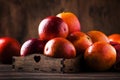 Juicy ripe shiny red bloody oranges in tray for making refreshing cocktail on rustic wooden table background, still life,