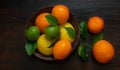 Juicy ripe slices of orange, lemon, grapefruit and lime on a dark background. Sliced citrus in a basket on a brown wooden table. Royalty Free Stock Photo