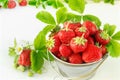 Juicy ripe tasty strawberries in  metal bucket on white wooden table Royalty Free Stock Photo