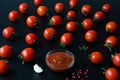 Juicy ripe tomatoe and and tomato sauce or ketchup in glass bowl. Royalty Free Stock Photo