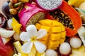 Juicy ripe tropical Thai fruits on a wooden dish.