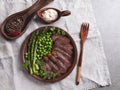 Juicy roasted beef chopped steak, with green peas, asparagus, on plate close up Royalty Free Stock Photo