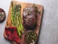 Juicy roasted meat steak with asparagus, pepper, sauce, close up