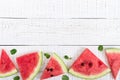 Juicy slices of a ripe watermelon on a white wooden background. Berry food background