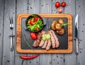 Juicy steak medium rare beef with spices and grilled vegetables Royalty Free Stock Photo