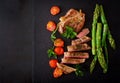 Juicy steak medium rare beef with spices and tomatoes, asparagus. Royalty Free Stock Photo