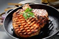 Juicy steak with parsley in a frying pan, onions, knife and fork on a gray background Royalty Free Stock Photo