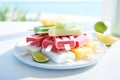 Juicy summer popsicles, ice cream of different flavors, with lemon, strawberry, orange, pineapple, on a plate on a white Royalty Free Stock Photo