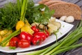 Juicy, summer vegetable salad cutting from fresh vegetables and greens in a beautiful serving on a wooden table Royalty Free Stock Photo