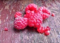 Juicy tasty raspberries. Red berries on an old shabby bench. Healthly food