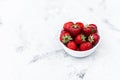 Juicy tasty strawberries in a white plate on the table. Royalty Free Stock Photo