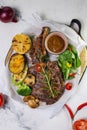 Grilled steak with vegetables and mushroom on white background