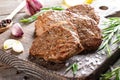 Juicy thick juicy portions of fried steak fillet with spices on old wooden board