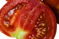 Juicy tomatoes isolate on white background with copy space. Red tomato cut in half, juice and seeds macro Royalty Free Stock Photo