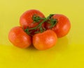 Juicy tomatoes on a yellow background Royalty Free Stock Photo