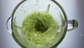 Juicy vegetables blended mixer swirling inside bowl closeup in super slow motion