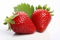 Juicy and vibrant red strawberries with fresh green leaves isolated on a clean white background Royalty Free Stock Photo