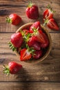 Juicy washed strawberries in wooden bowl on kitchen table Royalty Free Stock Photo