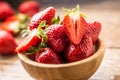 Juicy washed strawberries in wooden bowl on kitchen table Royalty Free Stock Photo