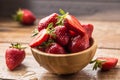 Juicy washed strawberries in wooden bowl on kitchen table Royalty Free Stock Photo