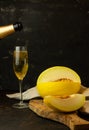 juicy yellow melon with a glass of champagne Royalty Free Stock Photo