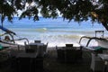 Jukung boats in front of seaside terrace on sunny day in Bali, Indonesia