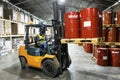 Jule 21, 2021 Khabarovsk, Russia: Forklift truck transports pallets of oil barrels in a warehouse