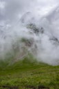 Julian Alps mountain Mangart from Mangrt saddle, Slovenia\'s Highest Panoramic Road, foggy weather