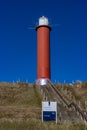 Julianadorp, Noord-Holland, Netherlands. April 17, 2021. Stairs to the Zanddijk Groote Kaap, round red steel lighthouse Royalty Free Stock Photo