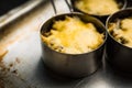 Julienne with chicken, cheese and mushrooms served in small metal bowl