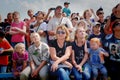 Viewers watch as Aircraft Modelers launch aircraft models at an airshow on a summer day