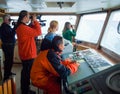 A group of young scientists are observing on the navigating bridge of a scientific vessel. Royalty Free Stock Photo