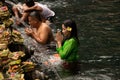 14 July 2018: Bali Indonesia:Indonesian and tourism pray and bath themselves in the sacred waters of the fountains, in Tirta Empul