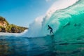 July 29, 2018. Bali, Indonesia. Surfer ride on barrel wave. Professional surfing in ocean at big waves