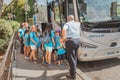 group of happy kids on a school excursion near the bus