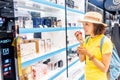 Happy Woman tries new perfume fragrances in perfume shop