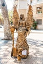 Street artist sculpture angel posing for tourists at the Rambla street