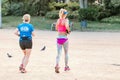 two female joggers running in park